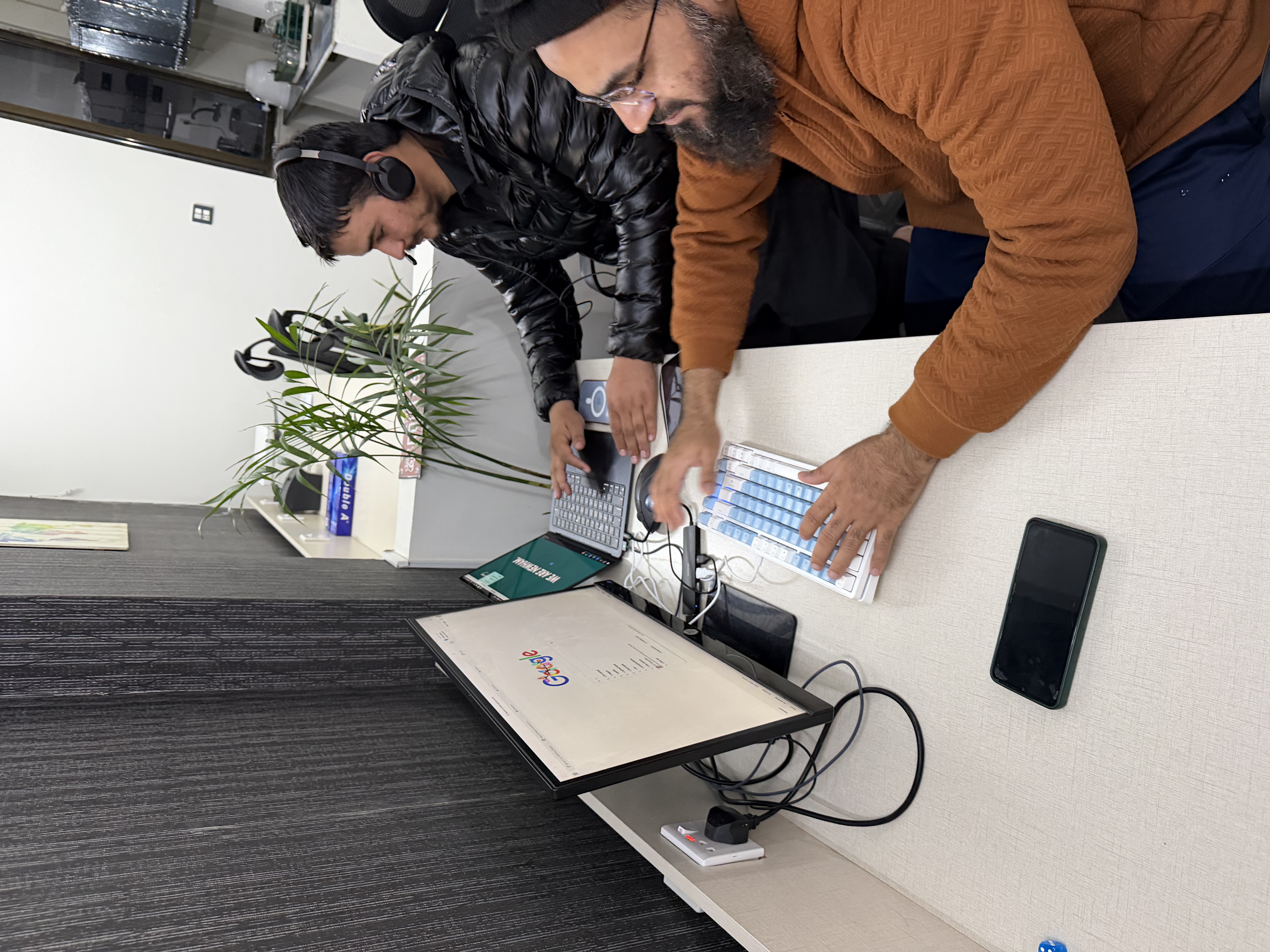 Shared desk area with people working